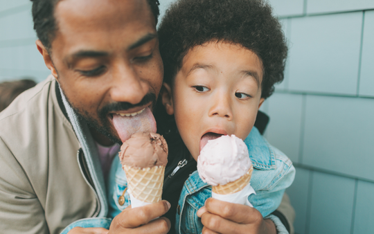 Dad and son eating ice cream cones
