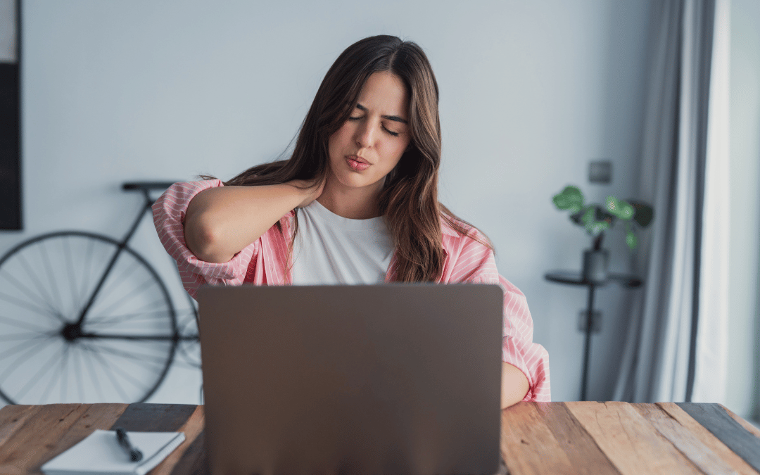 Woman at computer with tense shoulders